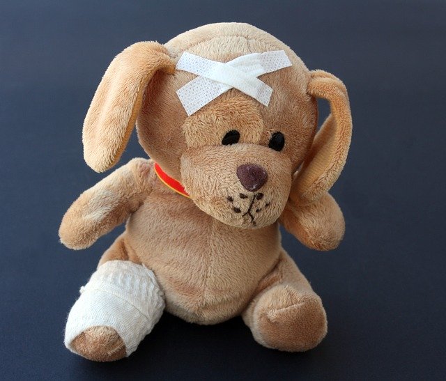 Teddy bear with a bandaged leg and head