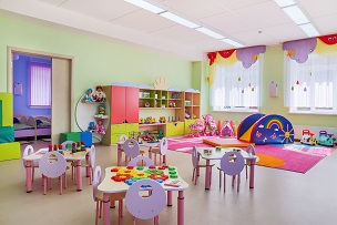 Picture of a room with tables and chairs in an early years setting