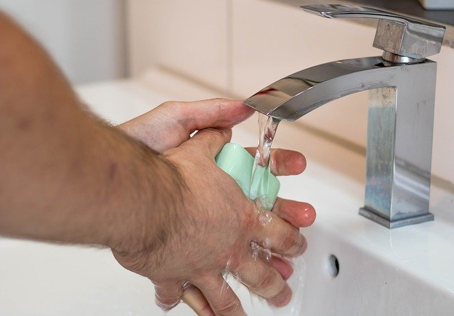 Male hand washing with soap