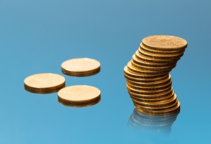 Stack of gold coins and 3 single gold coins