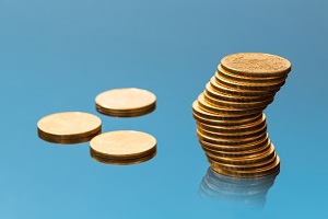 Stack of gold coins and 3 single gold coins