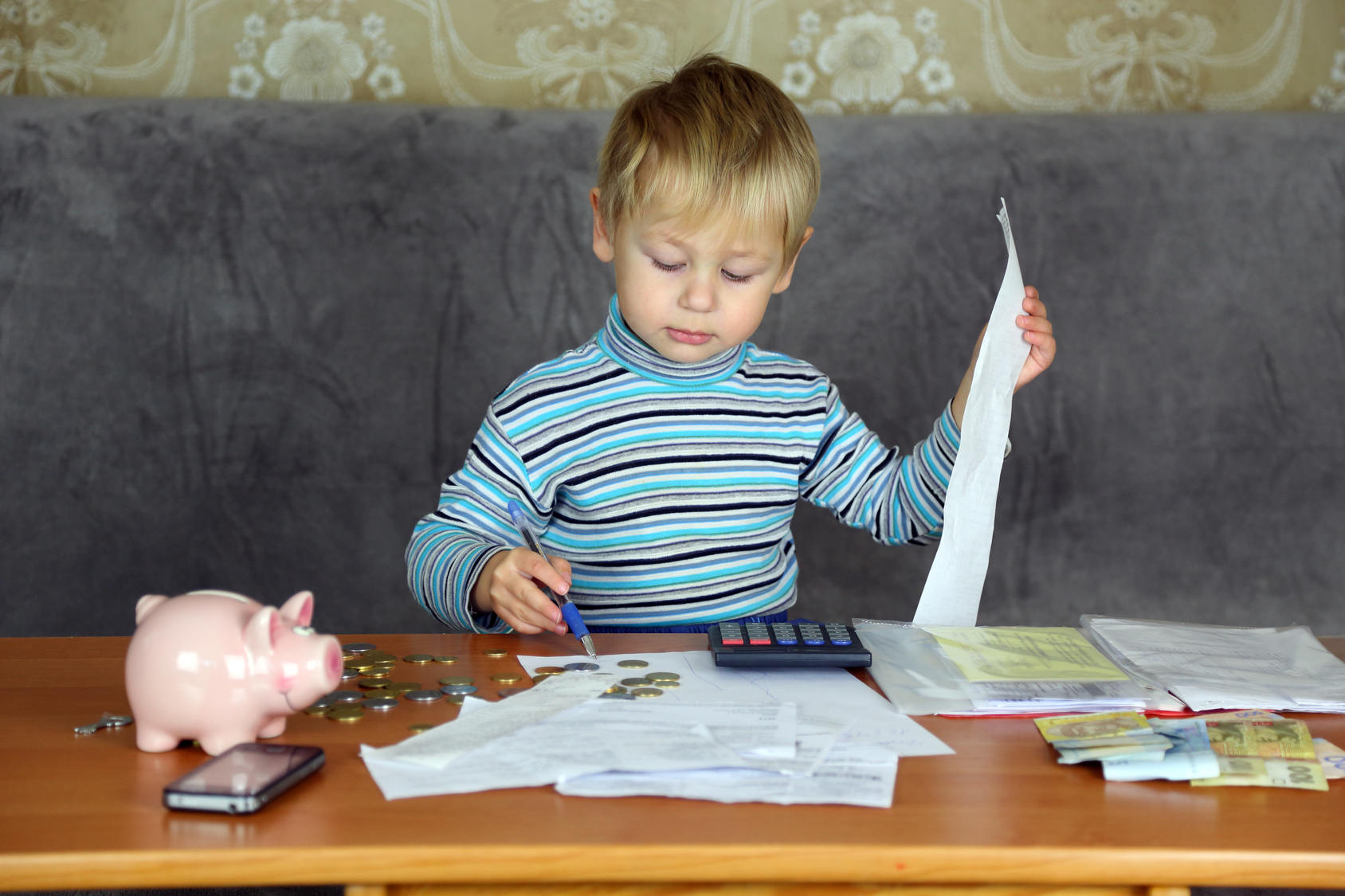 Pre school boy counting money