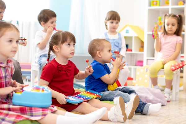 Young children sitting on the floor in a nursery setting
