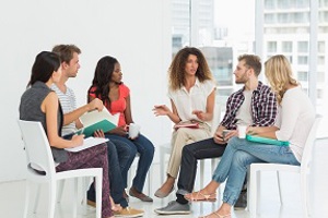 Adults seated having dicussion
