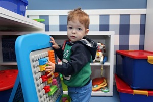 Boy playing with a Lego board