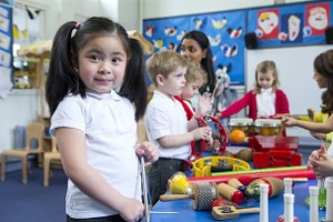 Children in classroom with a range of musical instruments on a table