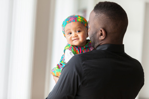 Adult man holding a young child