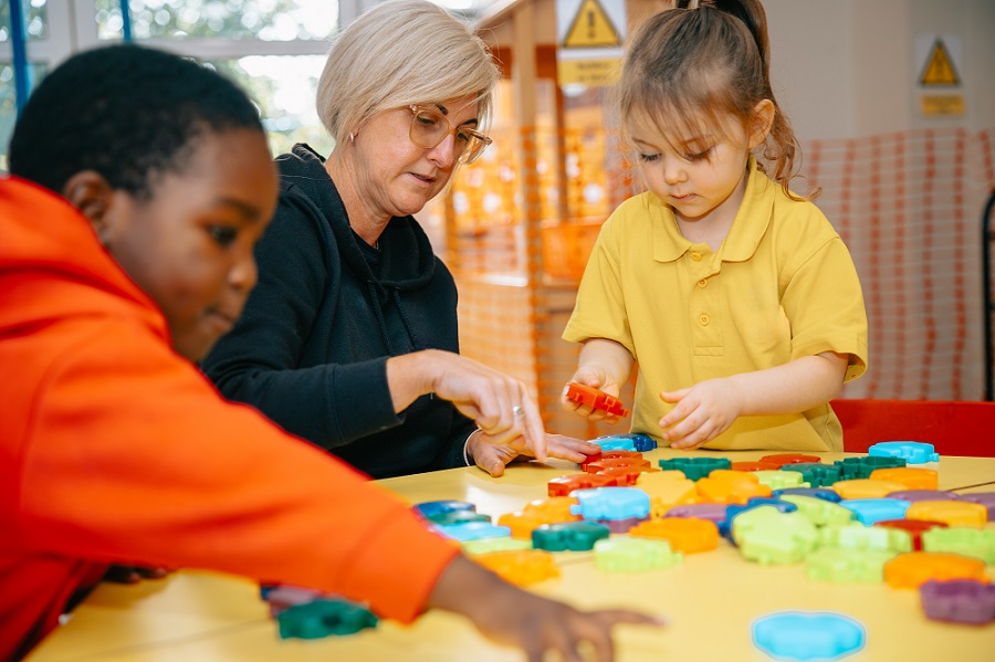 Adult playing with young children