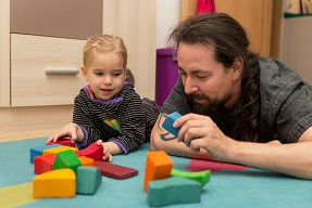 Childcarer and young girl playing