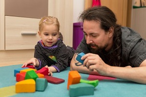 Childcarer and young girl playing