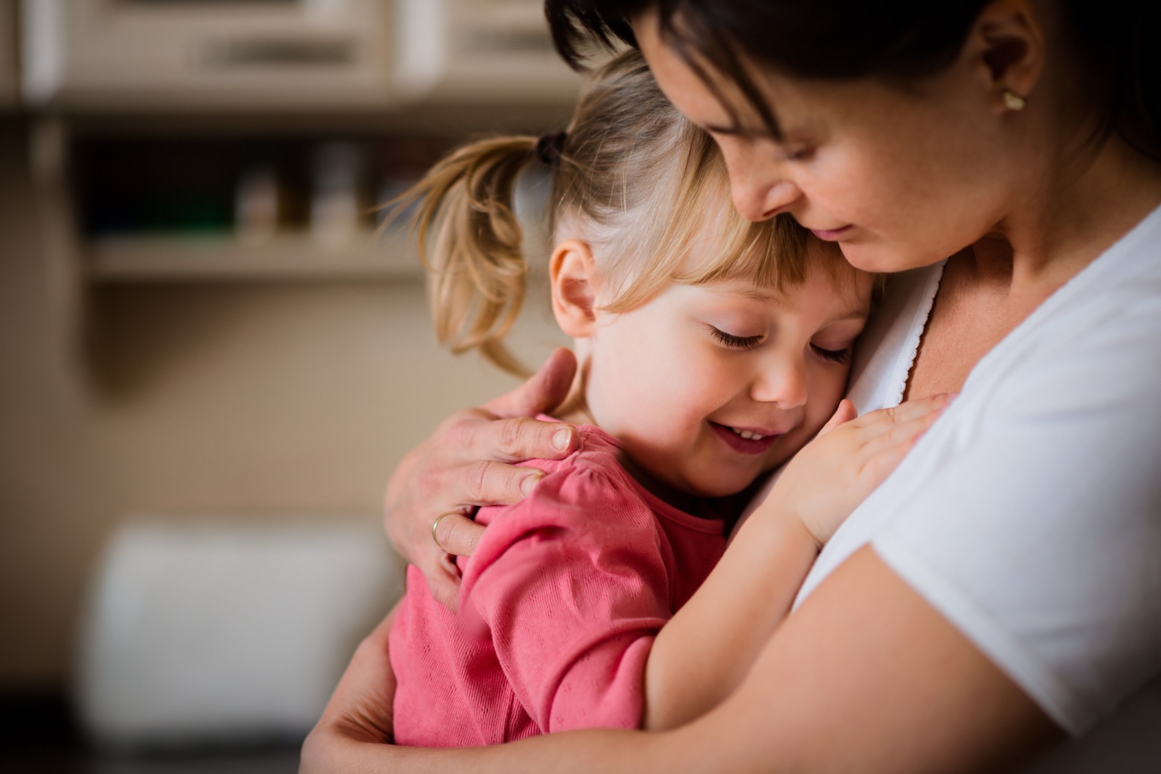 Woman embracing a young girl