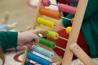Young childs hand playing with abacus
