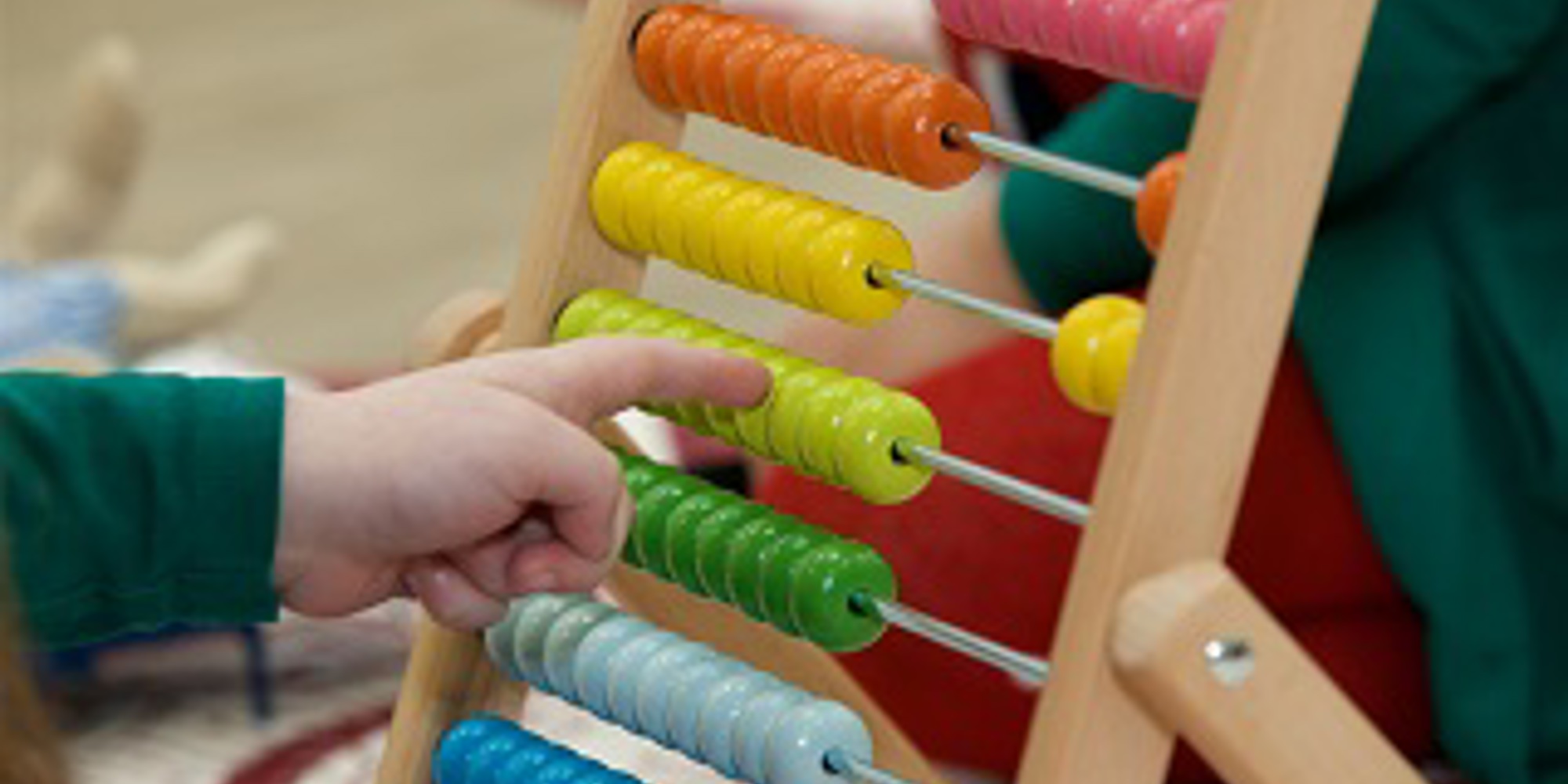 Young childs hand playing with abacus