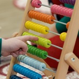 Young childs hand playing with abacus