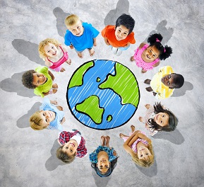 Children standing in a circle around an image of Earth