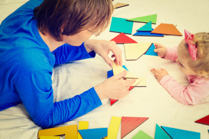 Adult and child playing with shapes