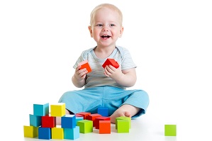 Baby boy playing with toy bricks