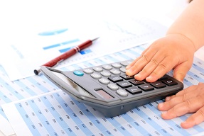 Young child's hand using a calculator