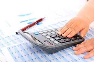Young child's hand using a calculator