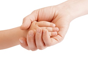 Adult hand holding a child's hand
