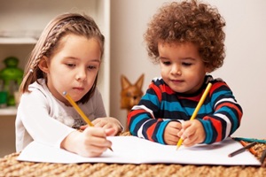 Young boy and girl writing